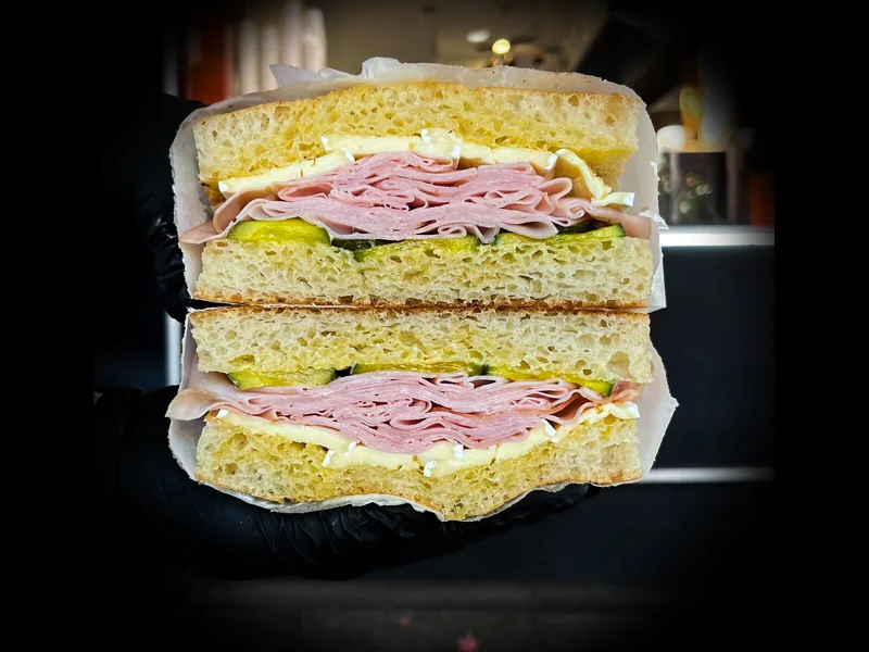 Ham and Brie sandwich: smoked ham, brie, salted butter and pickles on focaccia