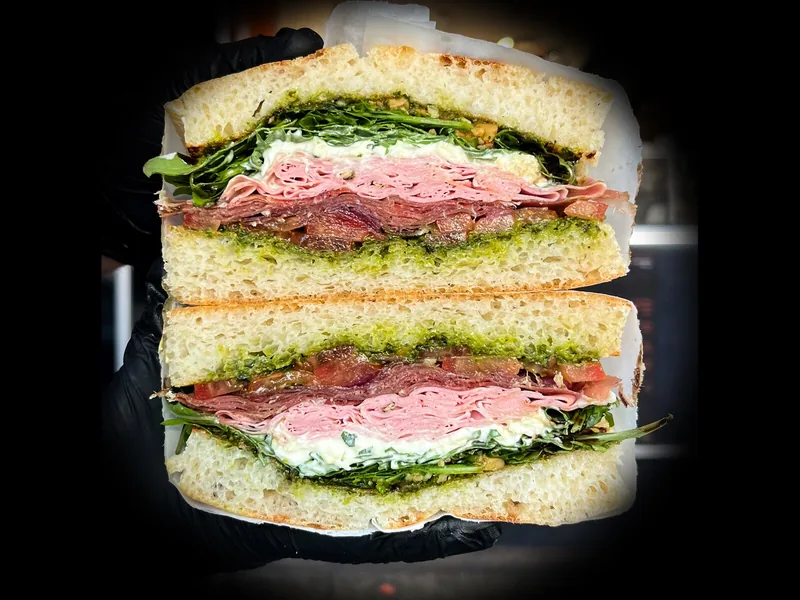 Italian Stack sandwich: prosciutto, mortadella, stracciatella, pesto and rocket on focaccia