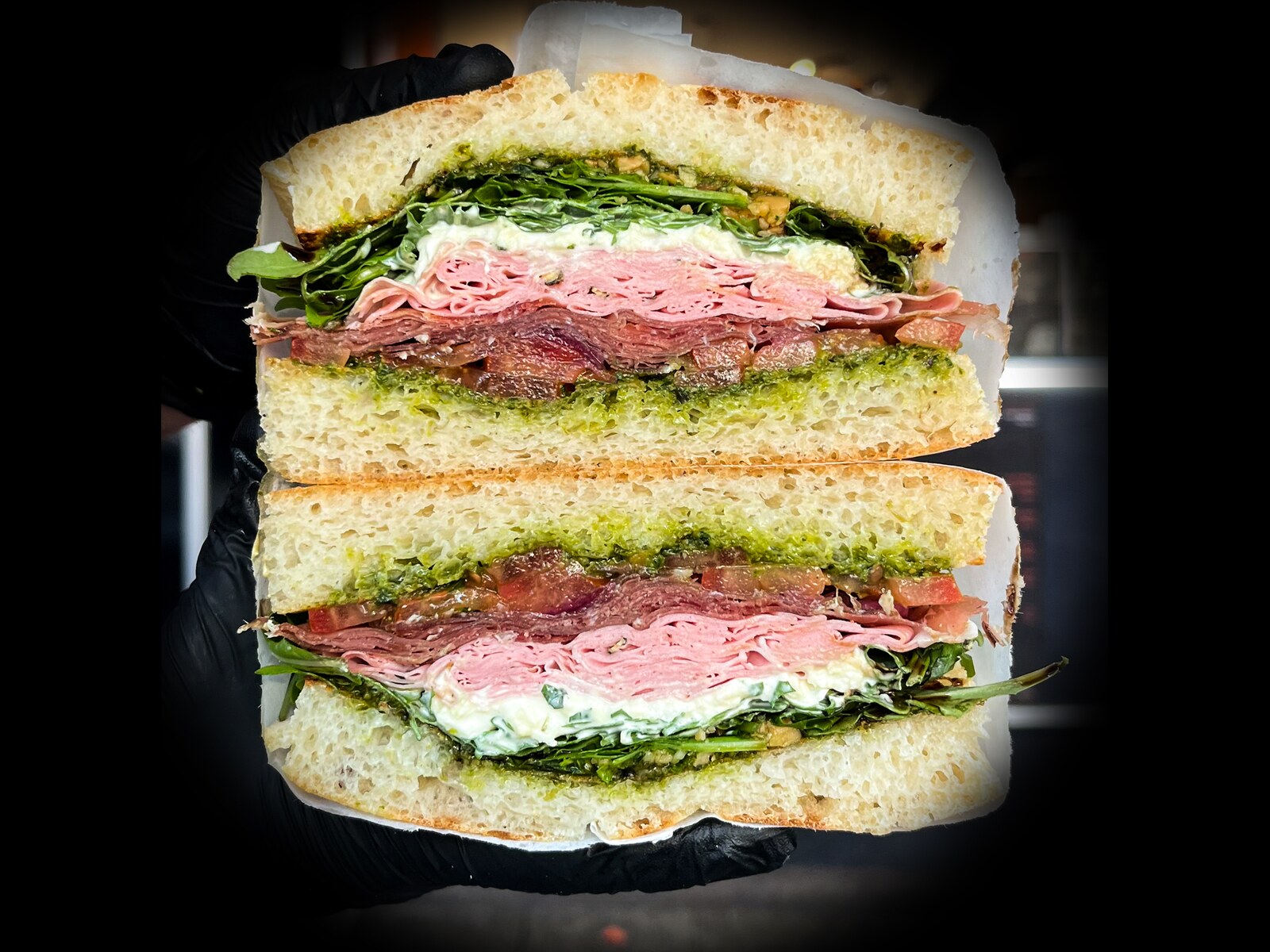 Italian Stack sandwich: prosciutto, mortadella, stracciatella, pesto and rocket on focaccia